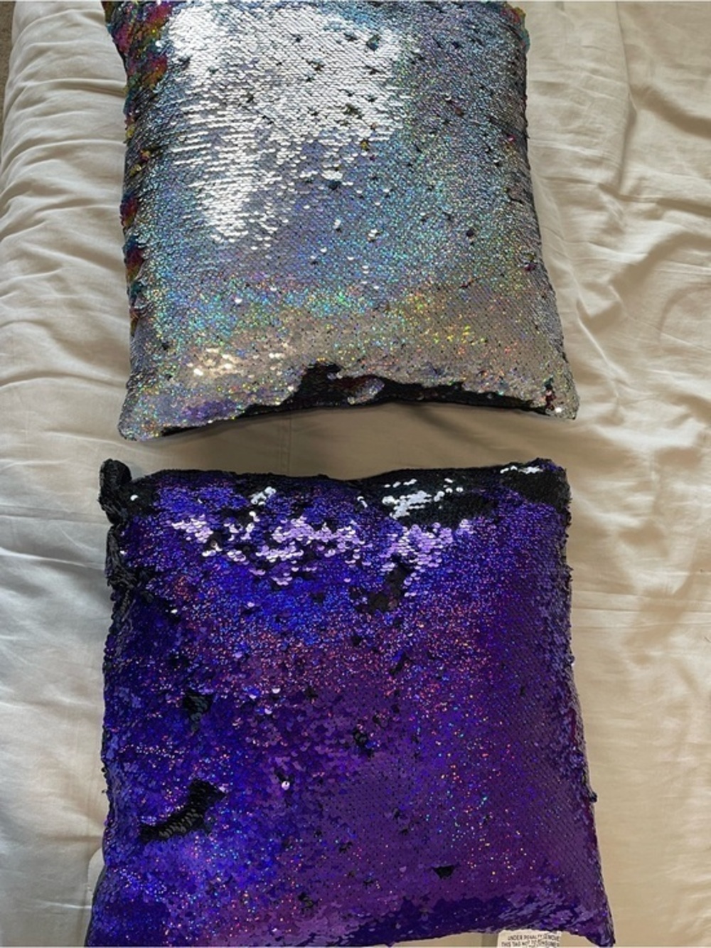 2 pillows. One Sequin Reversible Purple/black & one Rainbow/silver pillows